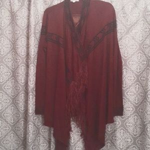 Womens long sleeve sweater cardigan with fringe accent.